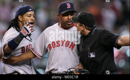 Red Sox Manny Ramirez (left) questions being called out by home plate umpire Chris Guccione (right) during the fifth inning against the Arizona Daimondbacks at Chase Field in Phoenix on June 10, 2007.  Trying to get between Ramirez and Guccione is third base coach DeMarlo Hale. (UPI Photo/Art Foxall) Stock Photo