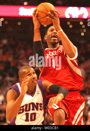 Houston Rockets Tracy McGrady (1) goes up for a shot during first quarter action against the Phoenix Suns at US Airways Center in Phoenix November 28, 2007.  Defending for the Suns is Leandro Barbosa (10) of Brazil. (UPI Photo/Art Foxall) Stock Photo