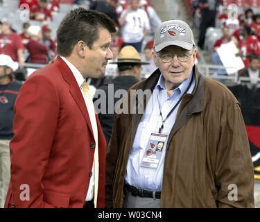 Arizona Cardinals owner Bill Bidwill (L) holds the George Halas Trophy as  commentator Terry Bradshaw (second from left,) interviews team president  Michael Bidwill (third from left) as coach Ken Whisenhunt (R) looks