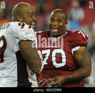 Arizona Cardinals guard Rex Hadnot (R) shares a laugh with Denver Broncos defensive end Kevin Vickerson (L) after the game at University of Phoenix Stadium in Glendale, AZ  December 12,2010.  The Cardinals defeated the Broncos 43-13.  UPI/Art Foxall Stock Photo