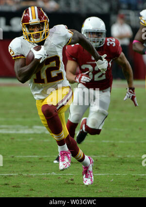 Washington Redskins wide receiver Art Monk (81) is stopped in his tracks by  New York Giants iinebacker Harry Carson (53) as he receives a Jay Schroeder  pass in the third quarter action