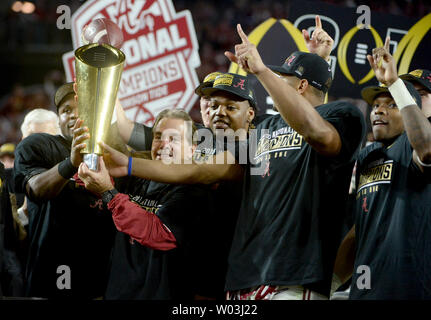 Alabama Crimson Tide coach Nick Saban is surrounded by his players as he holds up the championship after the 2016 College Football Playoff National Championship at University of Phoenix Stadium in Glendale, Arizona on January 11, 2016. Alabama defeated Clemson 45-40. Photo by Art Foxall/UPI Stock Photo