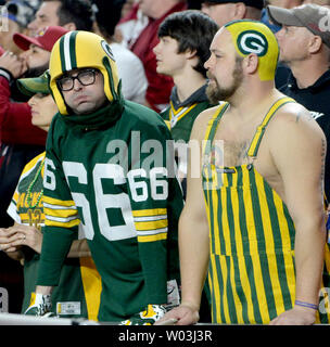 Two Green Bay Packers fans wear different style cheese head hats during the  first half of the Packers-Arizona Cardinals game at University of Phoenix  Stadium in Glendale, Arizona, December 27, 2015. Photo