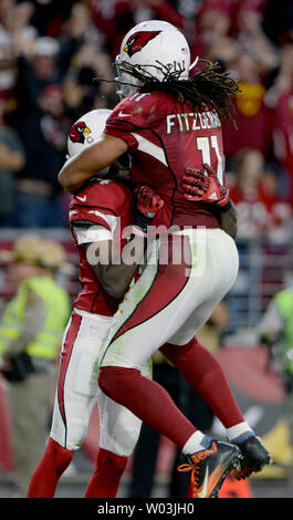 Arizona Cardinals' Larry Fitzgerald (R) jumps on David Johnson after Johns scored a twenty-five yard touchdown in the fourth quarter of the Cardinals-Washington Redskins game at University of Phoenix Stadium in Glendale, Arizona, December 4, 2016. The Cardinals defeated the Redskins 31-23. Photo by Art Foxall/UPI Stock Photo