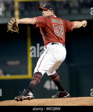 Arizona Diamondbacks pitcher Zack Godley (52) runs off the field at the ...