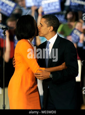 Democratic presidential candidate Sen. Barack Obama (D-IL) kisses his wife Michelle prior to delivering remarks at an election night rally after winning the North Carolina Primary at the North Carolina State University in Raleigh on May 6, 2008. Both North Carolina and Indiana held primaries today. (UPI Photo/Kevin Dietsch) Stock Photo