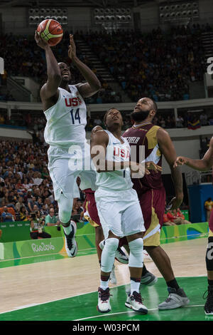 United States forward Draymond Green (14) goes for the jump shot as United States guard Kyle Lowry (7) blocks Venezuela center Gregory Echenique (0) during basketball competition at the Carioca Arena 1 in Rio de Janeiro, Brazil, August 8, 2016. The USA team overcame a slow start coasting to an easy 113-69 win over Venezuela.     Photo by Richard Ellis/UPI Stock Photo