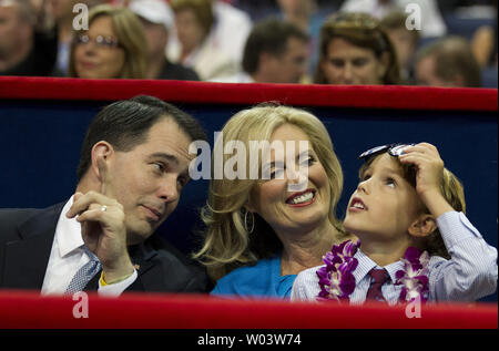 Wisconsin Governor Scott Walker (L), Ann Romney, and Romney grandson Parker watch the final session of the Republican National Convention at the Tampa Bay Times Forum in Tampa on August 30, 2012.   UPI/Mark Wallheiser Stock Photo