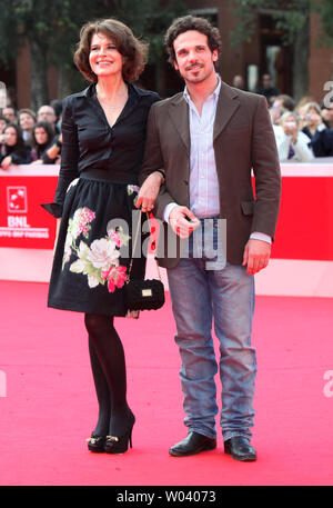 Fanny Ardant (L) and Francesco Montanari arrive on the red carpet before a screening of the film 'Chimeres Absentes (Absent Dreams)' during the 5th Rome International Film Festival in Rome on October 29, 2010.   UPI/David Silpa Stock Photo