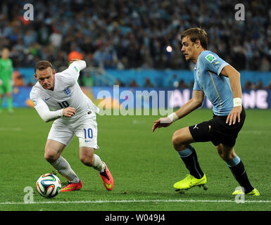 Sebastian Coates of Uruguay competes with Wayne Rooney (L) of England during the 2014 FIFA World Cup Group D match at the Arena Corinthians in Sao Paulo, Brazil on June 19, 2014. UPI/Chris Brunskill Stock Photo