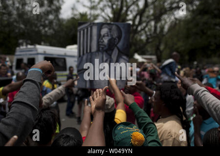 Large crowds came out to Nelson Mandela's former home in the Johannesburg suburb of Houghton to pay their respects and celebrate his life, South Africa, December 7, 2013. Mandela, former South African president and an icon of the anti-apartheid movement, died on December 5, at age 95 after complications from a recurring lung infection. UPI/Charlie Shoemaker Stock Photo