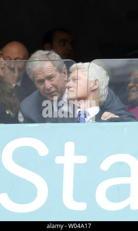 Former US Presidents George Bush and William Jefferson Clinton are seen at the memorial service for former South African President and anti-apartheid leader Nelson Mandela, at FNB Stadium in Johannesburg, South Africa, December 10, 2013. Nearly 100 heads of state and roughly 100,000 mourners attended the service for Mandela who died last week at the age of 95. UPI/Jemal Countess Stock Photo