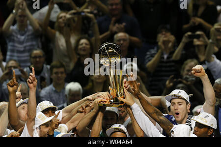 The San Antonio Spurs celebrate with the Larry O'Brien trophy after  defeating the Miami Heat following game 5 of the NBA Finals at the AT&T  Center at the AT&T Center in San