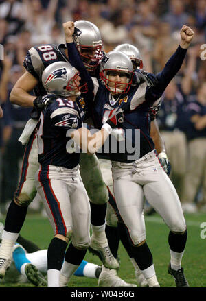 Kicker Mike Vanderjagt, of the Indianapolis Colts, embraces kicker Adam  Vinatieri, of the New England Patriots, following the Patriots victory over  the Colts, in the AFC Championship Game, Sunday, January 18, 2004