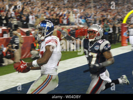 New York Giants Plaxico Burress catches a 52 yard pass over New England  Patriots (27) Ellis Hobbs III in the first quarter at Giants Stadium in  East Rutherford, New Jersey on December