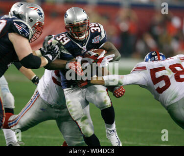 New England Patriots running back Laurence Maroney takes a pass for four yards before being brought down by New York Giants linebacker Antonio Pierce in the third quarter of Super Bowl XLII in Glendale, Arizona, on February 3, 2008.    (UPI Photo/Gary C. Caskey) Stock Photo