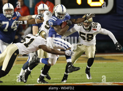 Indianapolis Colts running back Joseph Addai (C) runs against New Orleans Saints linebackers Jonathan Vilma (51) and Anthony Waters (59)during the first quarter at Super Bowl XLIV in Miami on February 7, 2010.        UPI/Aaron M. Sprecher Stock Photo