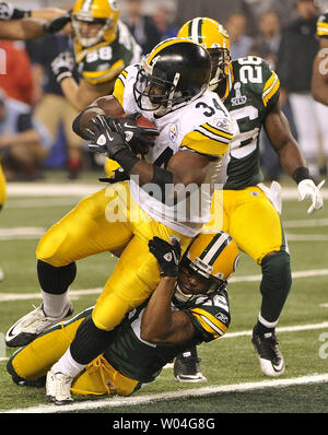 Green Bay Packers cornerback Pat Lee (R) dives to tackle Pittsburgh Steelers  running back Rashard Mendenhall in the third quarter during Super Bowl XLV  at Cowboys Stadium in Arlington, Texas on February