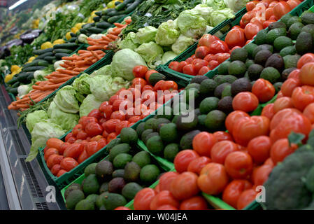 A supermarket aisle full of fresh, colorful vegetables Stock Photo