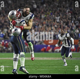 New England Patriots Rob Ninkovich (50) and WR Julian Edelman (R) celebrate  a Malcolm Butler interception of a Seattle Seahawks pass with 26 seconds  remaining in Super Bowl XLIX at University of