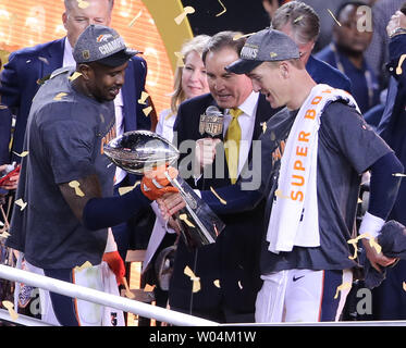 MVP Denver Broncos Von Miller (L) hands the Vince Lombardi Trophy