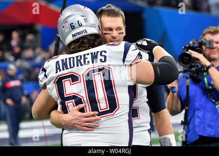 New England Patriots quarterback Tom Brady (12) gives a hug to New England Patriots center David Andrews (60) before the start of Super Bowl LIII against the Los Angeles Rams at Mercedes-Benz Stadium on February 3, 2019 in Atlanta.  Photo by Kevin Dietsch/UPI Stock Photo