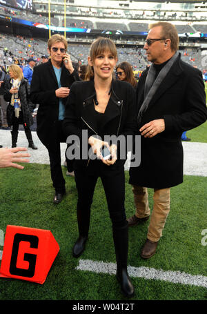 Actor Kevin Costner walks on the field before the NFL Super Bowl