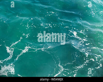 Splashing foamy waves on the sea surface. Stock Photo