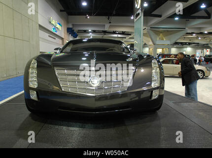 A visitor to the San Diego International Car Show looks over a new 2006 Cadillac Sixteen Concept car along with some of the over 400 2005 and 2006 model vehicles on display at the San Diego Convention Center, December 28, 2005 in San Diego California. The auto show is expected to attract over three hundred thousand people and is the six largest in the country, showcasing concept cars and new releases from the top automakers. ( UPI Photo/Earl S. Cryer) Stock Photo