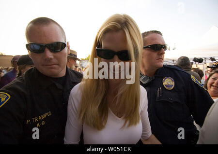 Author Ann Coulter leaves under heavy guard after signing autographs during the Sean Hannity Freedom Concert, August 2, 2006 at the Coors Amphitheater in Chula Vista, California featuring Country singers Hank Williams Jr, The Charley Denials Band and Lee Greenwood. (UPI Photo/Earl S. Cryer) Stock Photo