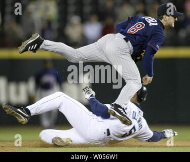 Minnesota Twins second baseman Nick Punto (top) turns a double play on  Toronto Blue Jays Edwin Encarnacion hit into by Blue Jays' Randy Ruiz  during eighth inning baseball action in Toronto on