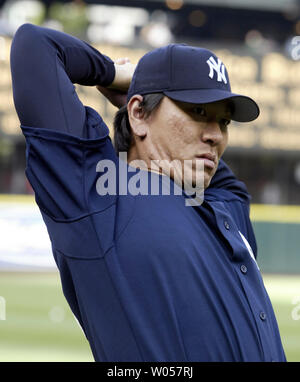 New York Yankees outfielder Hideki Matsui stretches out before their game against the Seattle Mariners in Seattle on August 24 2006. Matsui broke his left wrist May 11 and has been on the disabled list. (UPI Photo/Jim Bryant) Stock Photo