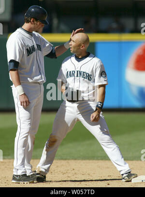 Seattle Mariners' Richie Sexson pats teammate Raul Ibanez on the head after Boston Red Sox' shortstop Alex Cora forced Sexson out at second base and then tagged out returning base runner Raul Ibanez, who was returning from third to second in the sixth inning in Seattle on August 27, 2006. Ibanez hit a fifth inning grand slam to help lead the Mariners past the Boston Red Sox 6-3. (UPI Photo/Jim Bryant) Stock Photo