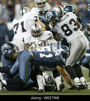 Seattle Seahawks defensive tackle Rocky Bernard (99) moves in on a sack of  St. Louis Rams quarterback Marc Bulger (10) during third quarter action.  The Seahawks came back and defeated the Rams