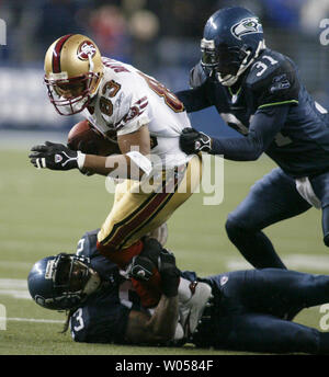 Dec 24, 2006; San Francisco, CA, USA; San Francisco 49ers wide receiver  ARNAZ BATTLE (#83) fumbles the ball while being tackled by Arizona  Cardinals ANTREL ROLLE (#21) in the second half of