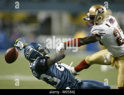 Seattle Seahawks wide receiver Deion Branch is tackled by New York Giants  safety Jason Bell after Branch made a catch in the first quarter of a NFL  football game Sunday, Sept. 24