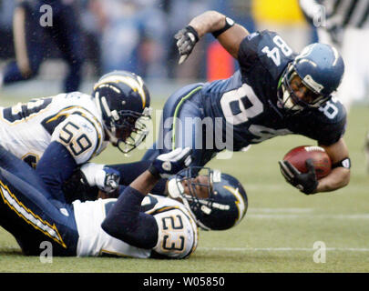 Seattle Seahawks wide receiver Bobby Engram, right, is tackled by San Diego Charger defenders Donnie Edwards (59) and Quentin Jammer (29) in the second quarter December 24, 2006 in Seattle. Engram caught four passes for 65 yards in the Seahawks 17-20 loss to the Chargers. (UPI Photo/Jim Bryant) Stock Photo