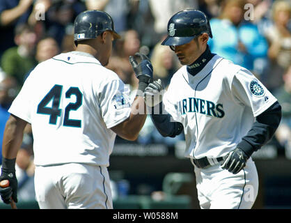 Seattle Mariners' Adrian Beltre, left, scores on a single by teammate Kenji  Johjima off Minnesota Twins pitcher Francisco Liriano in the fourth inning  of a baseball game Saturday, May 9, 2009, in