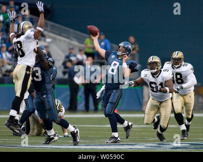 Seattle Seahawks' quarterback Matt Hasselbeck (C) is pressured by New Orleans Saints defenders Cornerback Usama Young, (L) and defensive ends Will Smith (91) and Renaldo Wynn (98) in the second quarter at Qwest Field in Seattle on October 14, 2007. Seahawks fullback Leonard Weaver is blocking Young. (UPI Photo/Jim Bryant). Stock Photo