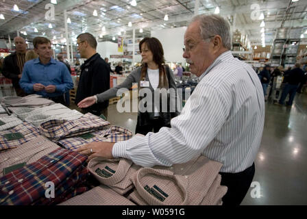 Costco co-founder Jim Sinegal (R) looks over a selection of shirts while talking with Tammi Laush, Assistant Merchandise Manager, during  the grand opening of a Costco in Gig Harbor, WA., on November 2, 2007.  (UPI Photo/Jim Bryant) Stock Photo