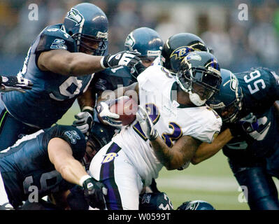 Baltimore Ravens' running back Willis McGahee (C) is brought down by the Seattle Seahawks defense  in the first half at Qwest Field in Seattle on December 23, 2007. (UPI Photo/Jim Bryant) Stock Photo