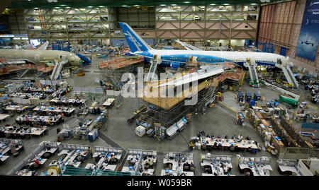 Boeing 787 jets are lined-up nose to tail and surrounded by rows of workers on computers in work stations as the planes are put together on the assembly line in the 787 Dreamliner plant during Boeing's Media Day on May 19, 2008 in Everett, Washington. The Dreamliner, the first new Boeing jet in 14 years, is being built in the 42-acre factory and is slated for its first flight sometime late in 2008. (UPI Photo/Jim Bryant) Stock Photo