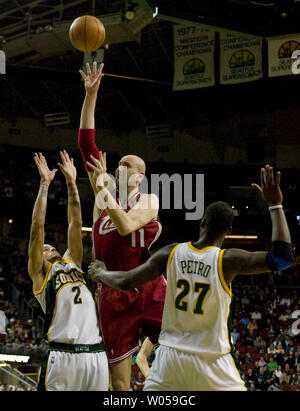 Cleveland Cavaliers'  Zydrunas Ilgauskas, of Lithuania, (C) shoots  against Seattle SuperSonics'  Delonte West (L) and Johan Petro of France (R) during the first half at the Key Arena in Seattle on January 31, 2008.  Ilgauskas scored 17 points  in the Cavaliers 95-101 loss to the SuperSonics. (UPI Photo/Jim Bryant) Stock Photo