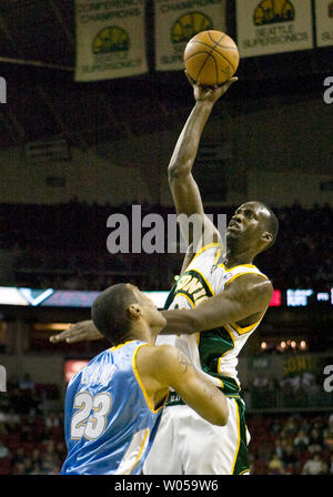 Seattle SuperSonics'  Johan Petro, of France (R) shoots over Denver Nuggets' Marcus Camby during the first half at the Key Arena in Seattle on February 27, 2008.  Petro scored 15 points as the Nuggets defeated the SuperSonics 138-96. (UPI Photo/Jim Bryant) Stock Photo