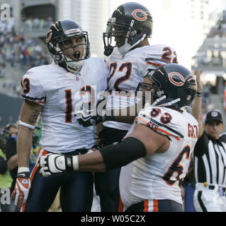 Chicago Bears wide receiver Johnny Knox (R) is tackled by Atlanta Falcons  defensive back Thomas DeCoud (28) and defensive back Dunta Robinson (23)  after a 25-yard reception during the first quarter at