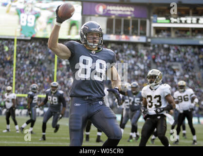 Seattle Seahawks tight end John Carlson heads upfield after catching a  25-yard pass against defending Arizona Cardinals linebacker Chike Okeafor  (L) in the third quarter at Qwest Field in Seattle on November