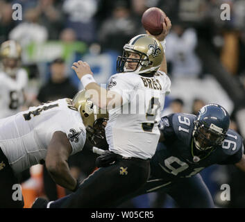 New Orleans Saints' quarterback Drew Brees passes under pressure from  Seattle Seahawks' defensive end Colin Cole in the fourth quarter of the  NFC's wild-card playoff game on Saturday January 8, 2011 at