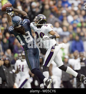 Baltimore Ravens cornerback Cary Williams, right, knocks the ball away from Seattle  Seahawks wide receiver Sidney Rice during the fourth quarter against the Baltimore  Ravens at CenturyLink Field in Seattle, Washington on