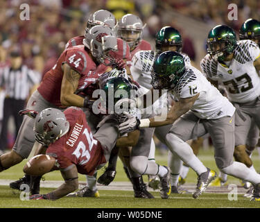 Washington State Cougars running back Teondray Caldwell fumbles the ball on a kick off  after being hit by Oregon Duck's Boseko Lokombo in the first quarter at CenturyLink Field in Seattle, Washington on September 29, 2012.  The Ducks scored on the next play as 2nd Ranked Oregon beat Washington State 51-26.     UPI/Jim Bryant Photo. Stock Photo