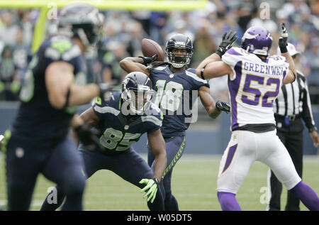 Seattle Seahawks wide receiver Sidney Rice (18), falls on his back after  catching a 23-yard touchdown pass from quarterback Russell Wilson while  being defended by Jacksonville Jaguars cornerback Will Blackmon (24) during